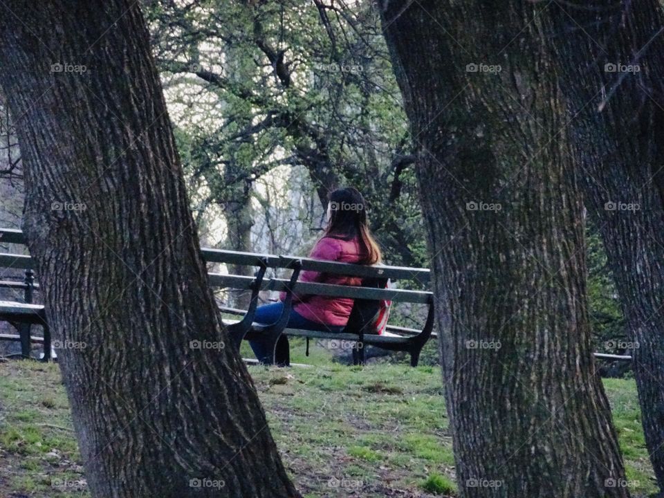 A woman sitting on a the bench 