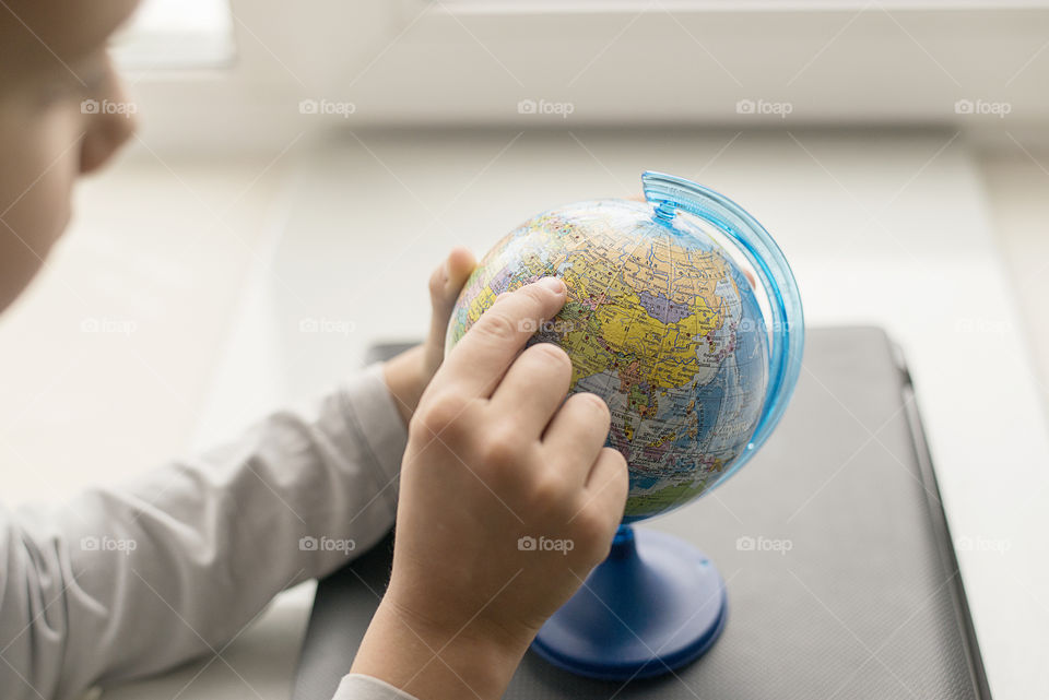 A child looking at globe