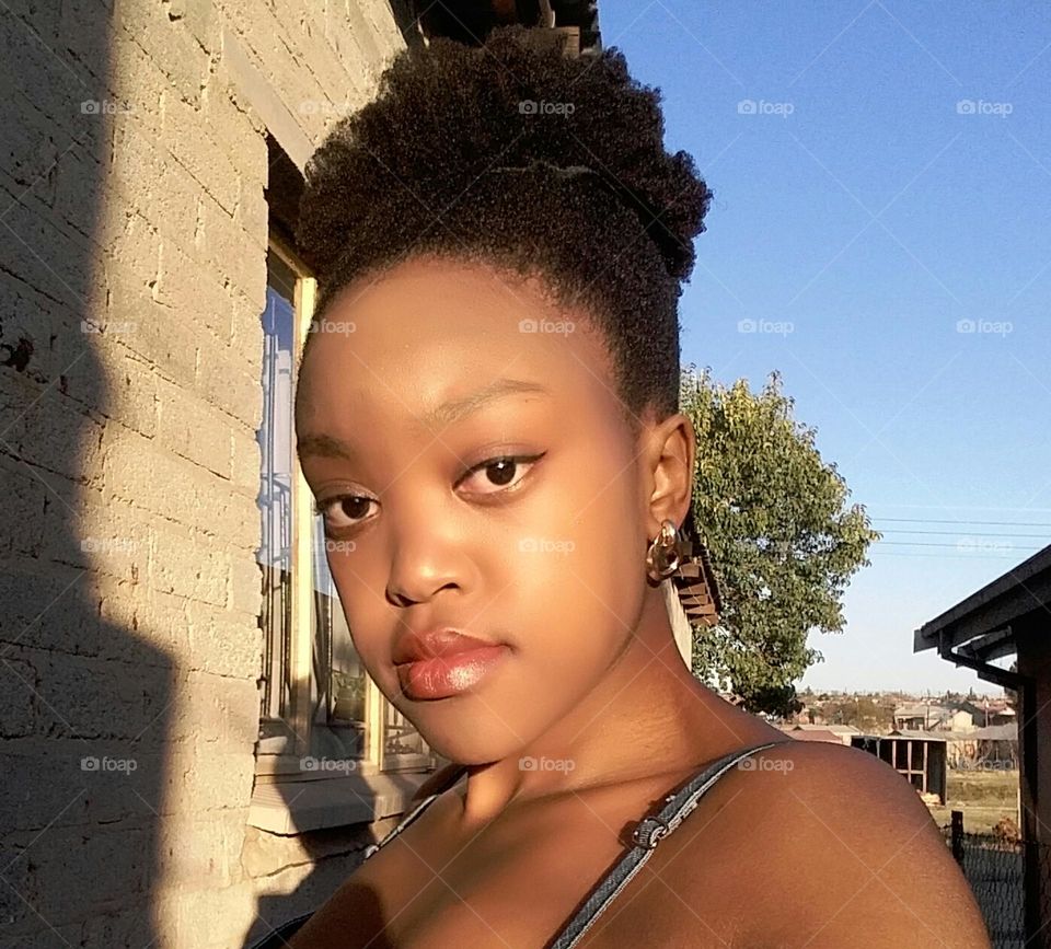 Black Woman with natural hair tied in a bun