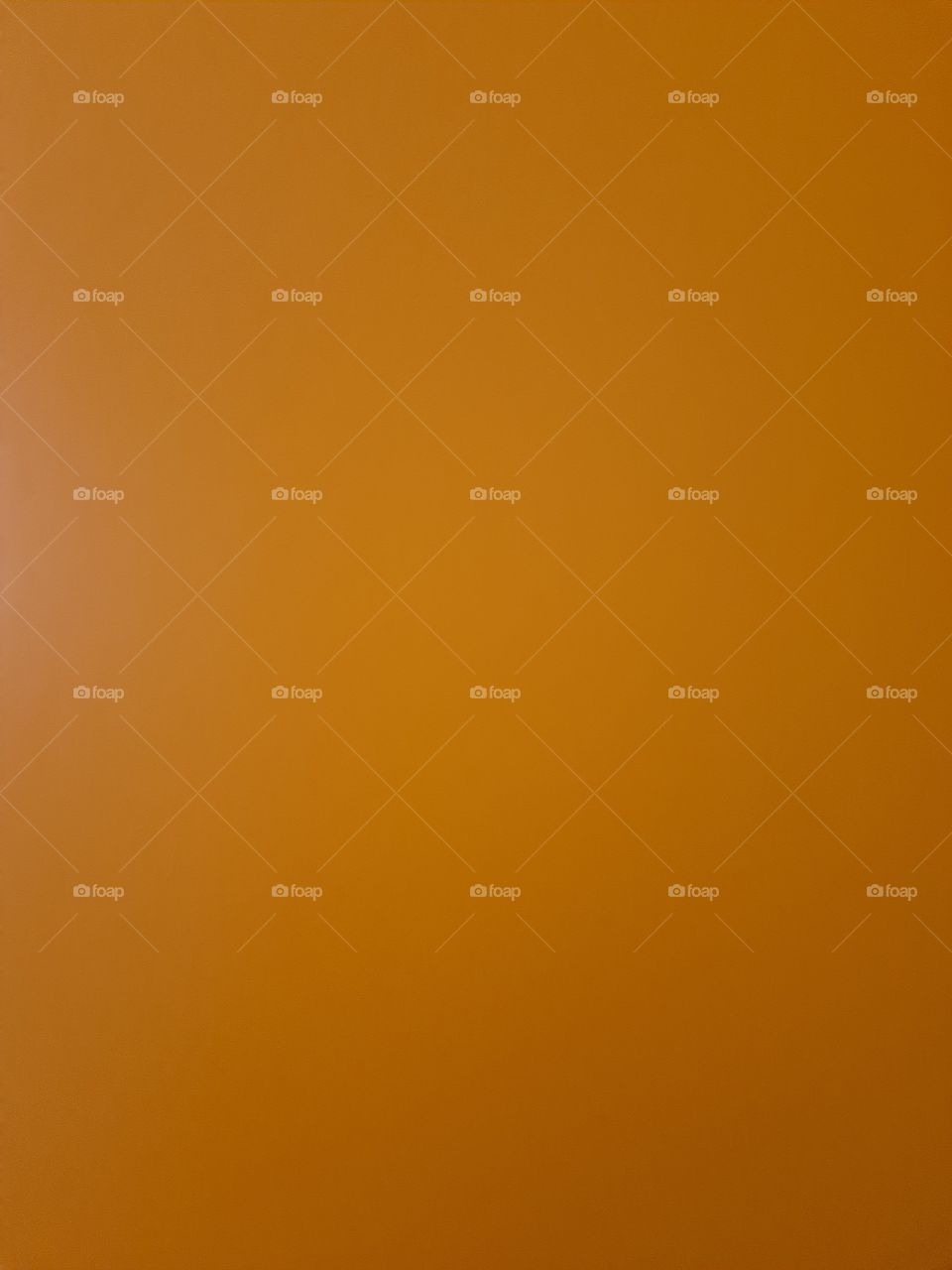 Close up of an orange wooden door of a closet.