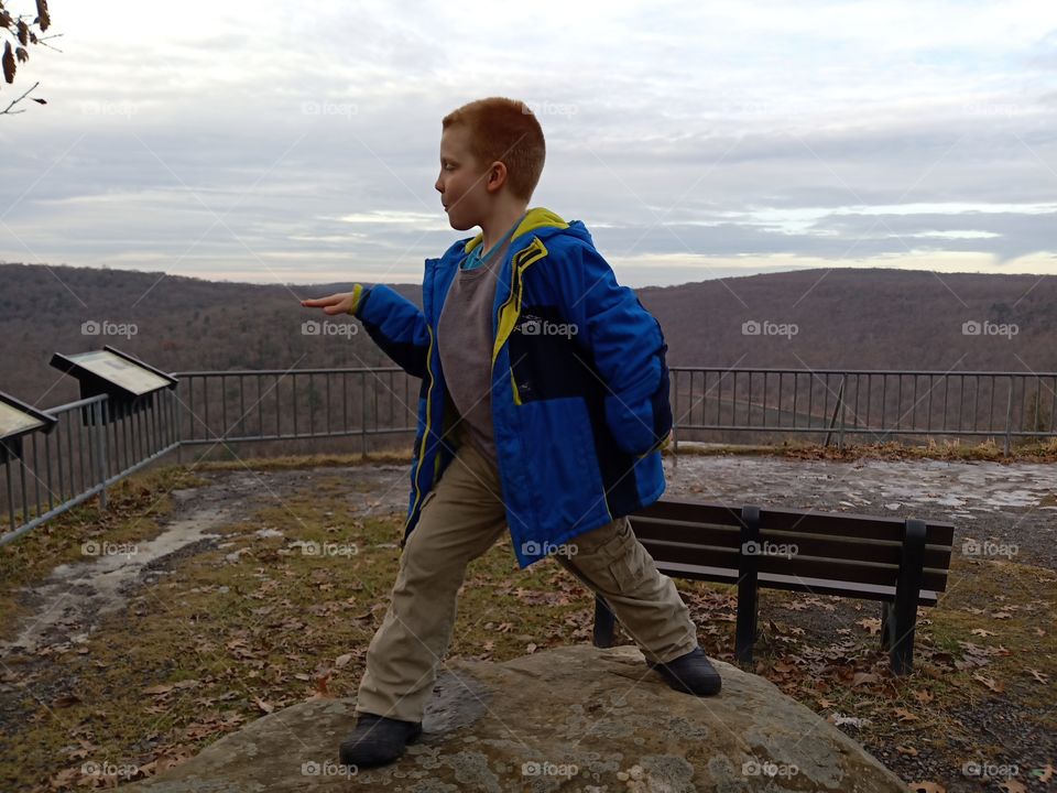 boy on rock poseing