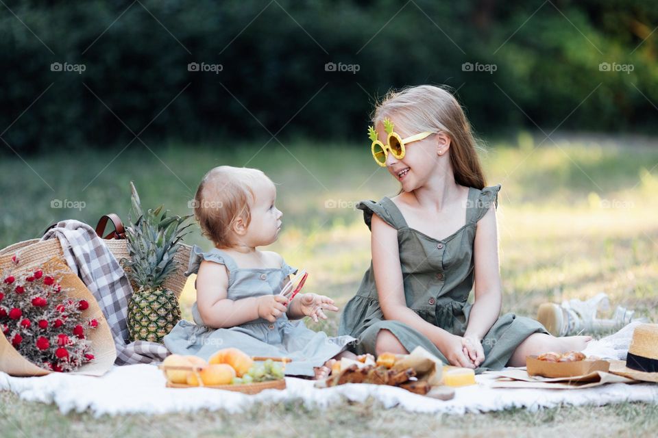 Happy Caucasian kids having picnic at summer 