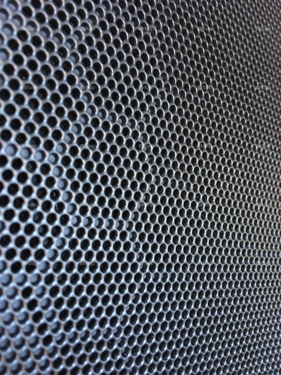 Close up texture. Metal speaker. Circles honeycomb shapes. 