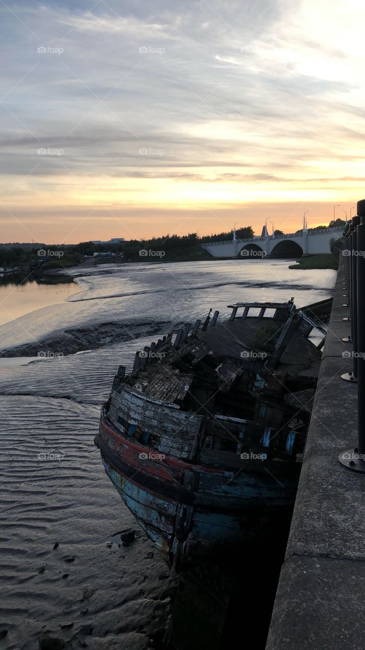 Ship wrecked under a beautiful sunset on the river Tyne 