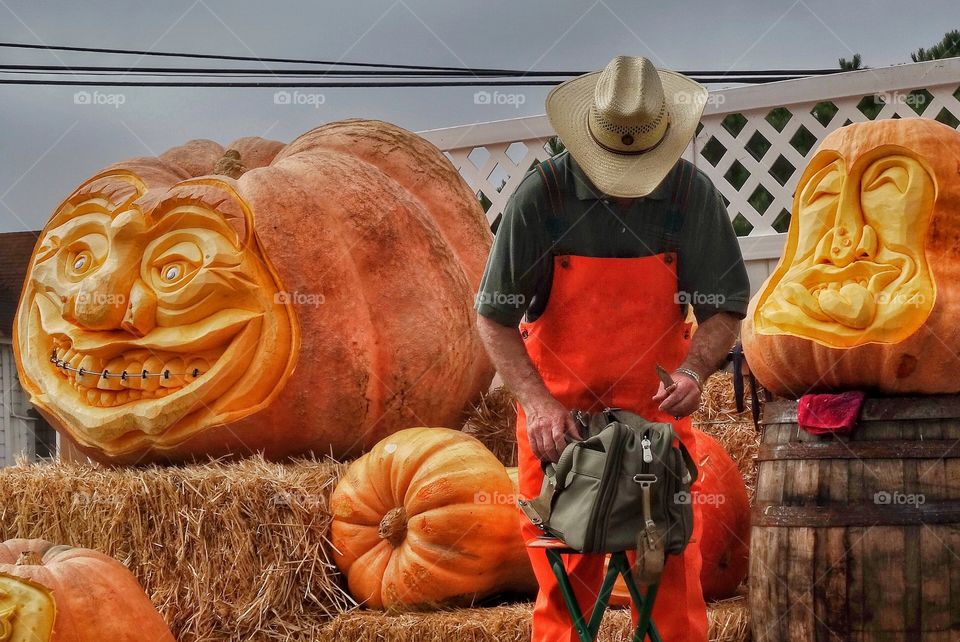 Artisanal Craftsman Carving Giant Pumpkins