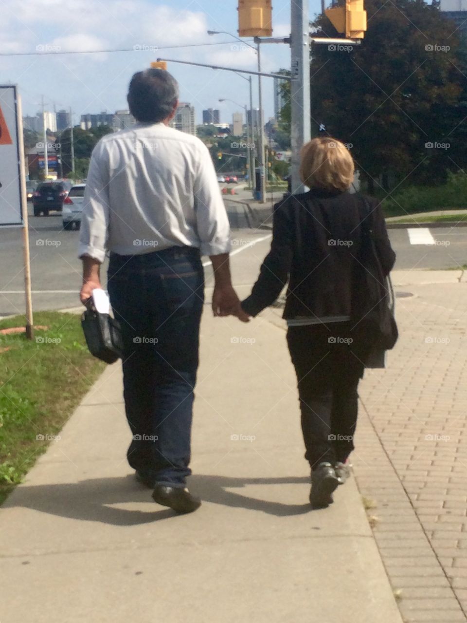 Old couple are holding hands