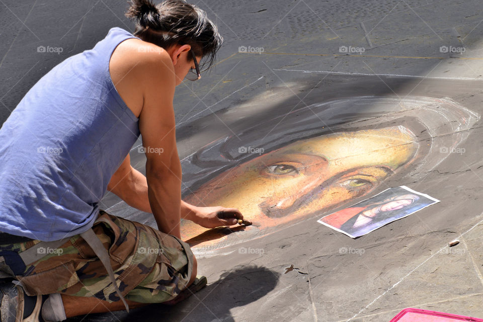 a young artist with colored chalks