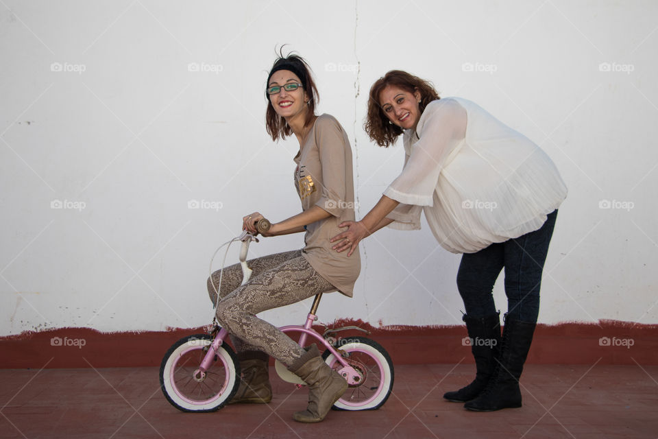 Bicycle girl plays with her mother