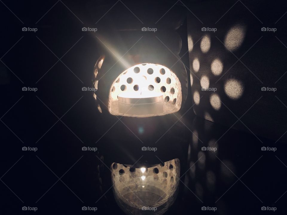 Candle light beams and reflection 