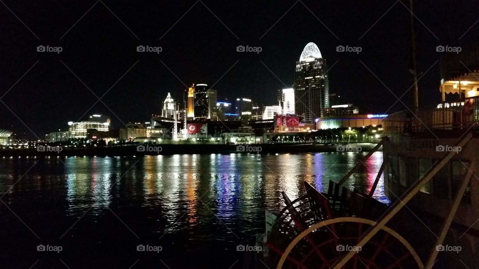 night time cityscape reflected in water