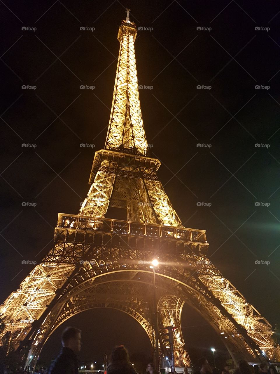 The Eiffel Tower brightly lit at night.