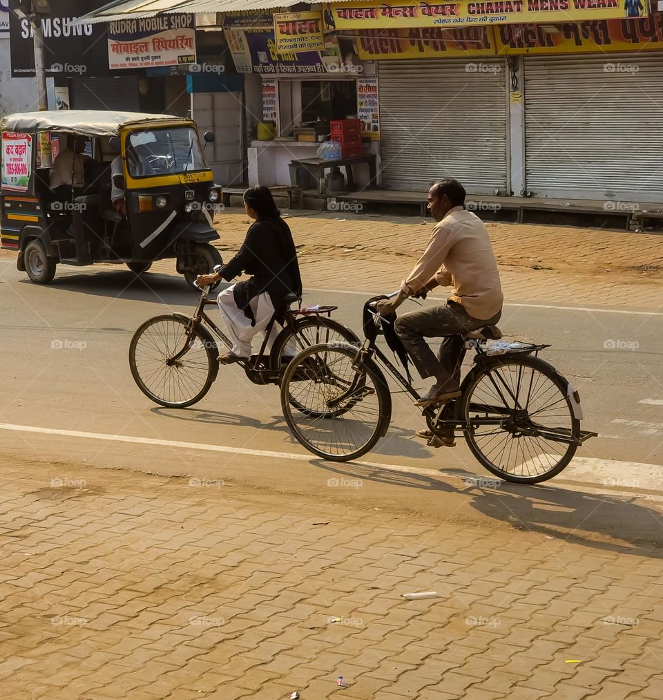 People on street riding bicycle