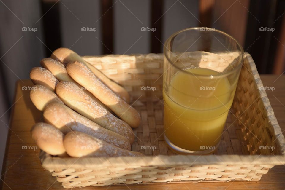 Oblong cookies in a wicker plate. Savoiardi cookies for dessert tiramisu.