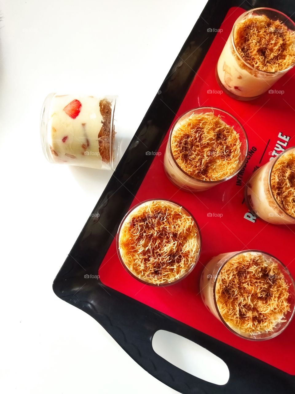 Cups of Turkish dessert made with strawberry and kadayif.