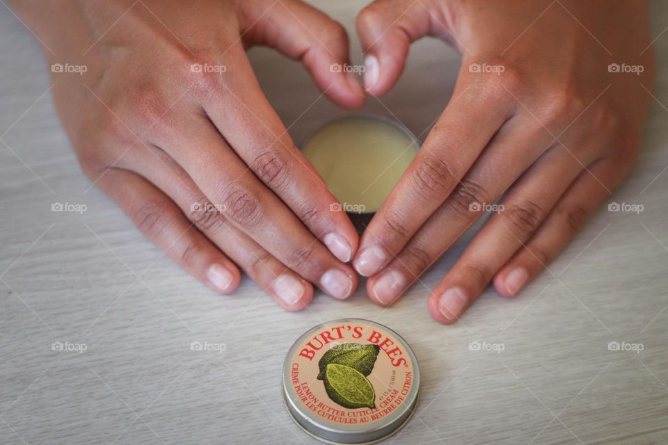 Beautiful woman's hands with Burt's Bees cuticle cream