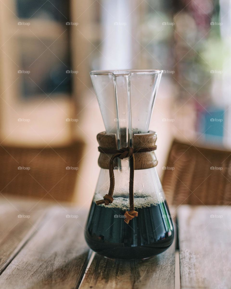 Chemex for coffee, filled with coffee, product small chemex coffeemaker on the table