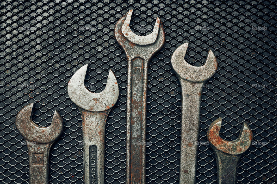 Old hardware tools. Wrench, screwdriver, measure, hammer, pliers on steel surface. Mechanic tools for maintenance. Hardware tools to fix. Technical background with copy space