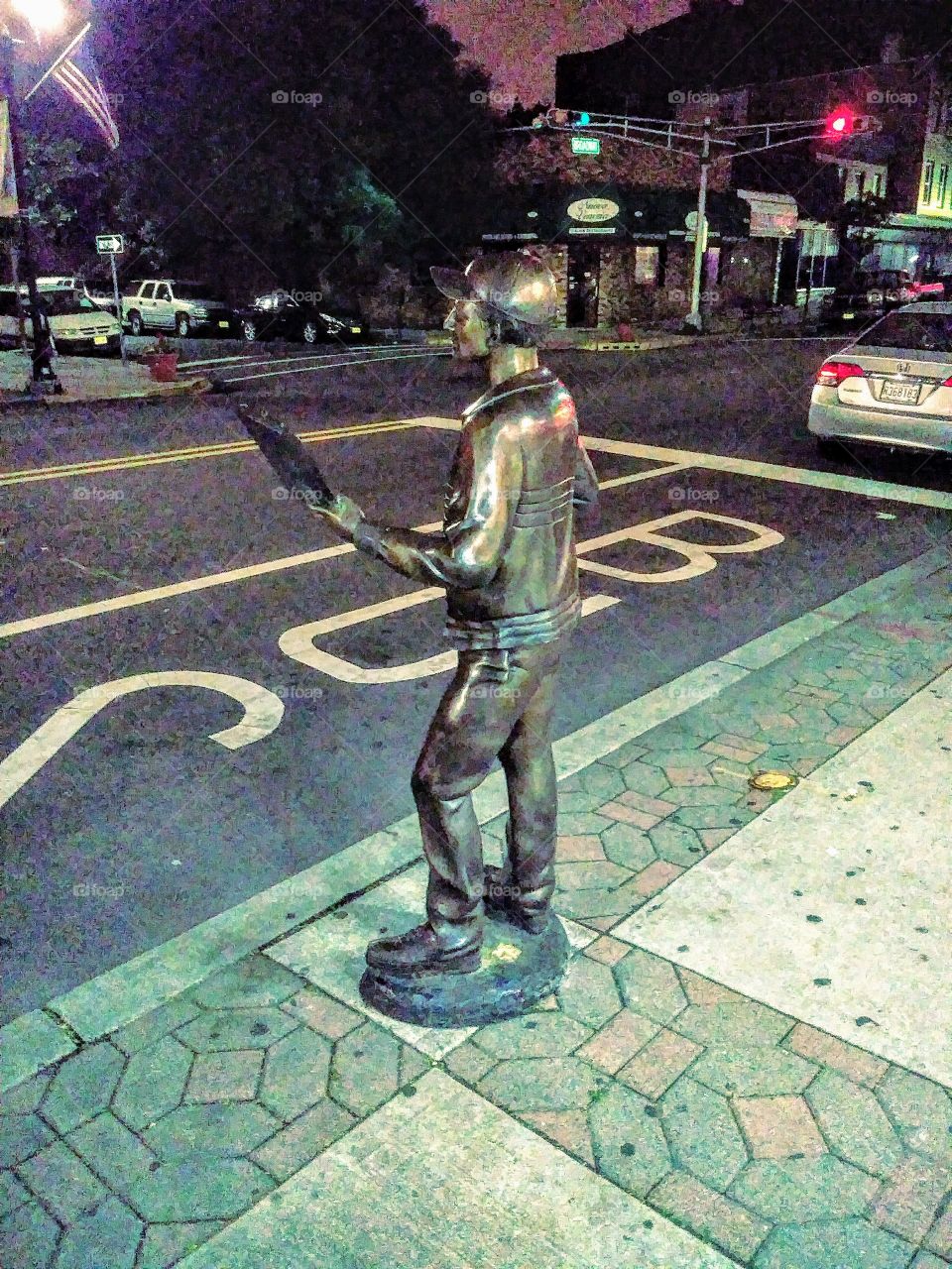 another view of the bronze delivery person sculpture not created to scale on Broadway in Bayonne New Jersey