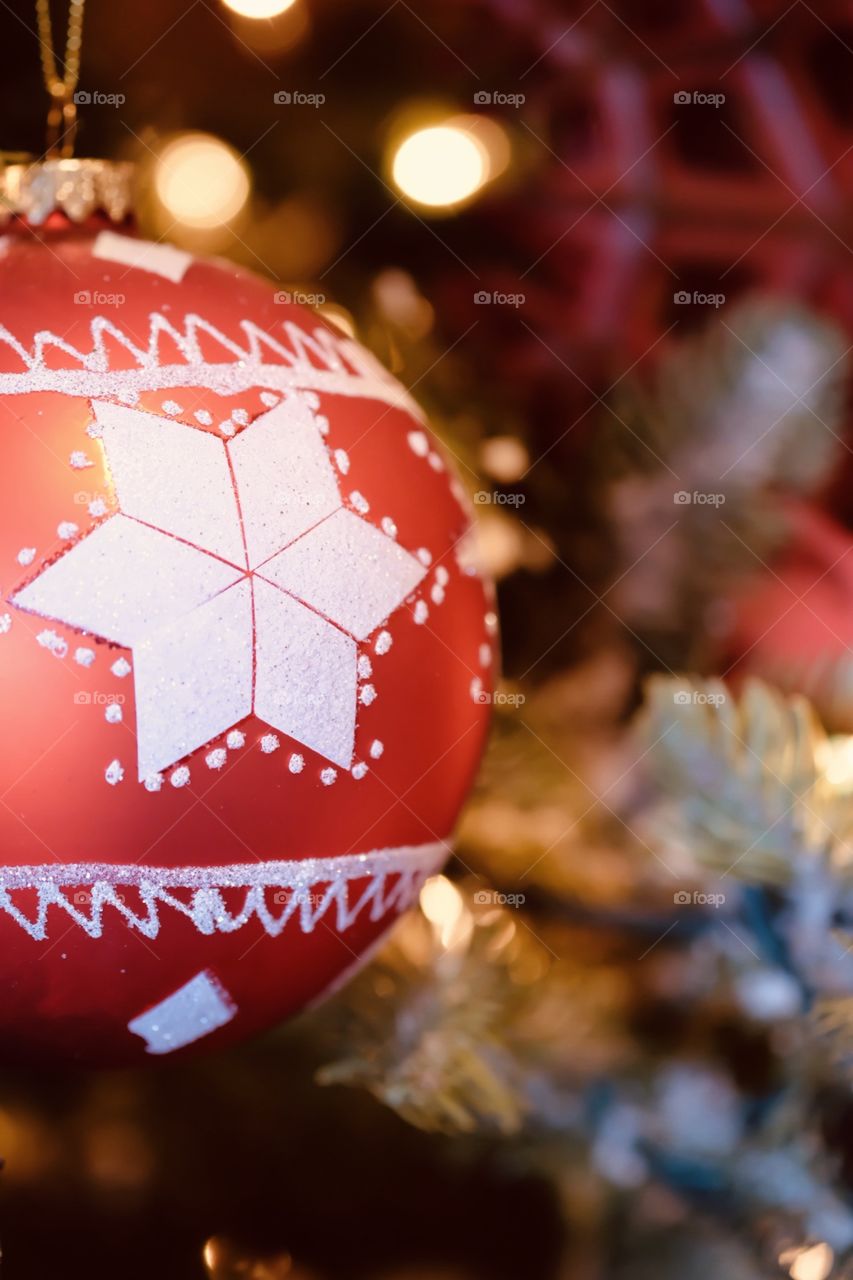 Red Star Ornament Closeup Shot With Blurred Christmas Tree, Taken In Ohio