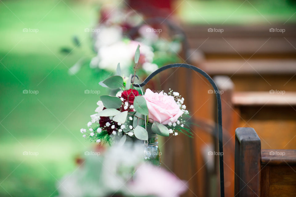 Red and Pink Roses in a Mason Jar Hanging in wedding Isle