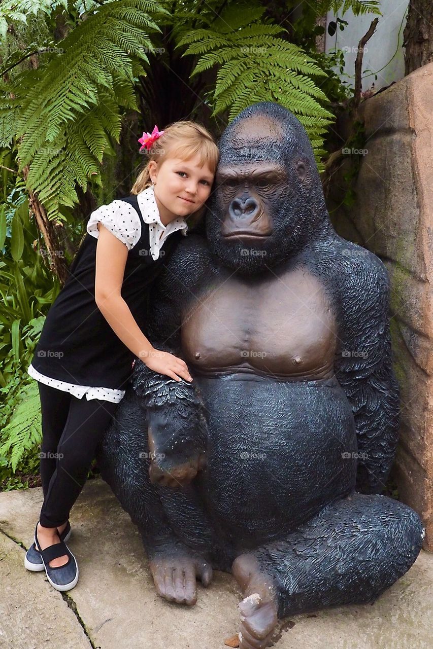 Girl with plastic gorilla