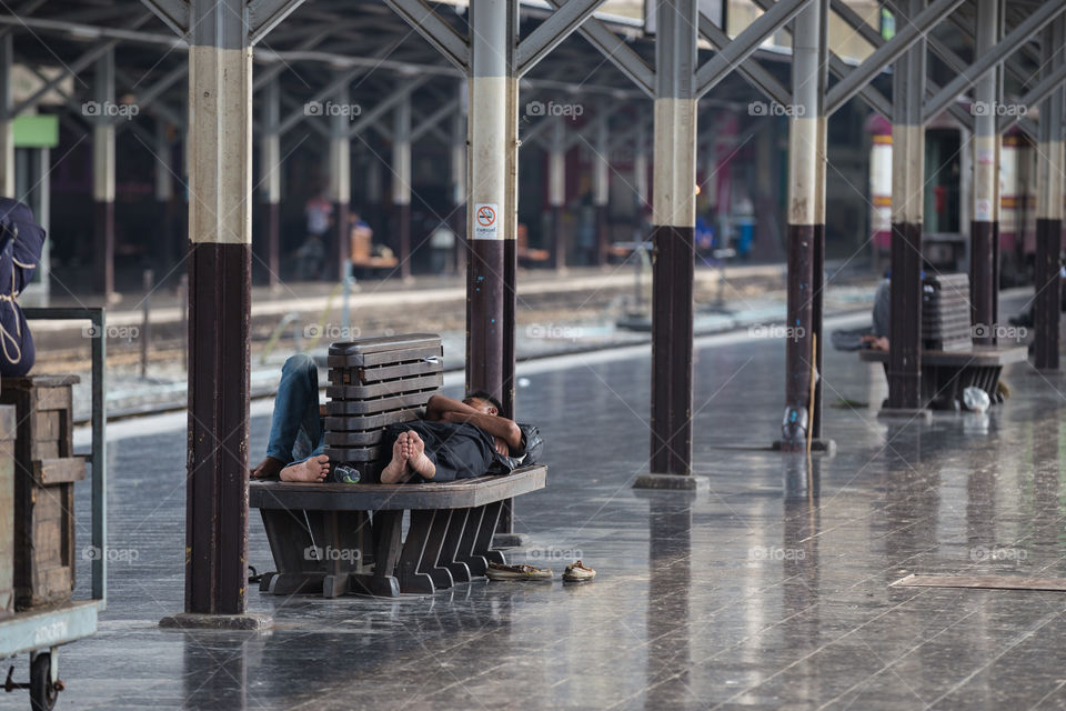 People sleeping in the train railway station in Hua Lamphong Bangkok Thailand 