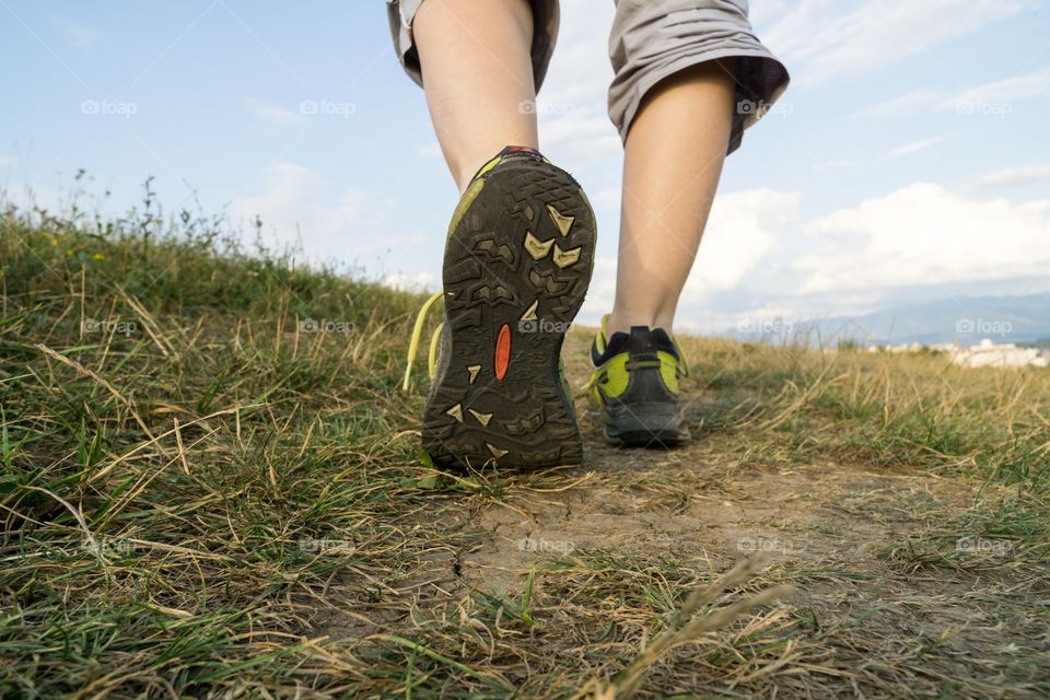 footsteps of the woman walking in the nature