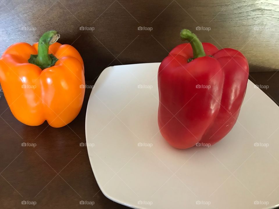 Two bell peppers - orange pepper and red pepper 