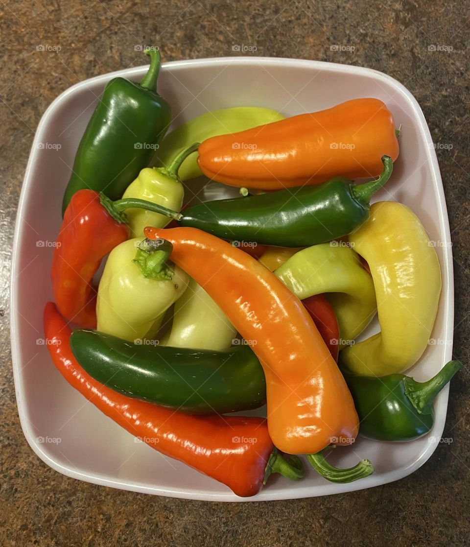 Brightly colored peppers in a white bowl