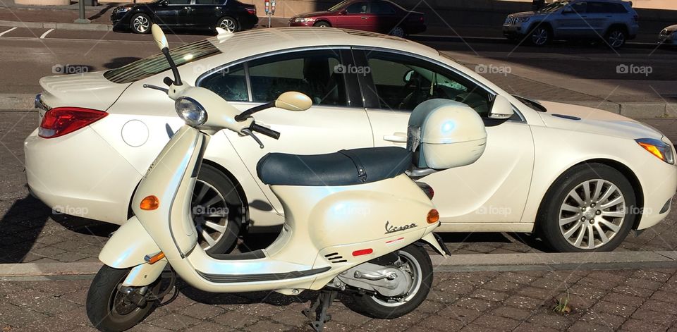 Vespa and car together and iridescent