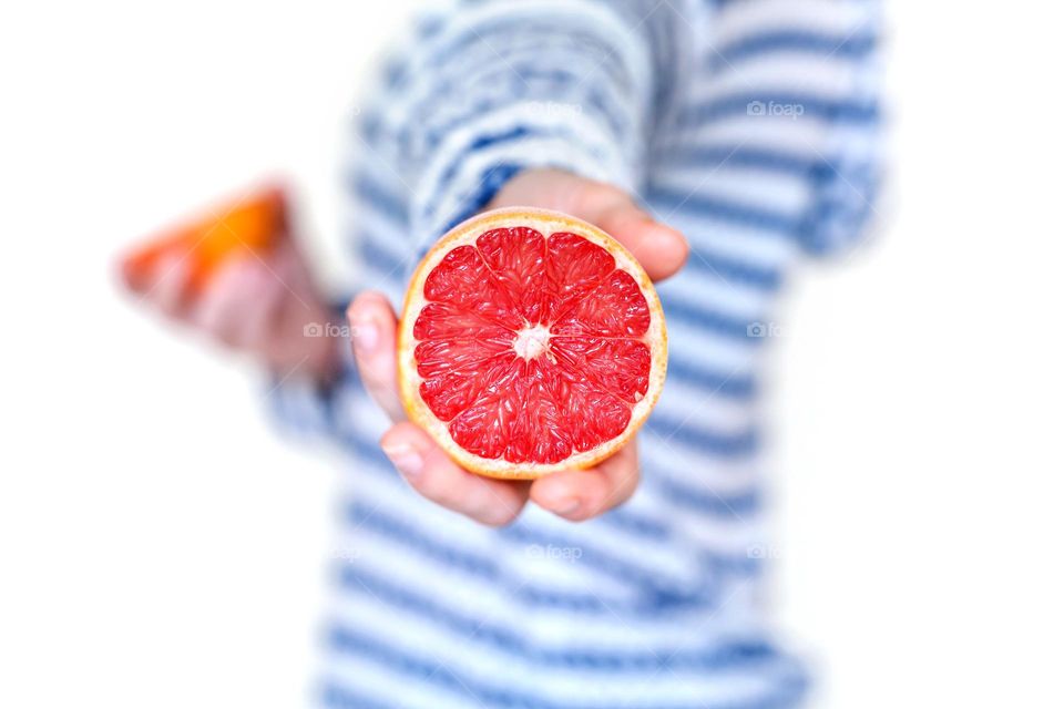 Juicy grapefruit in woman hands, healthy lifestyle