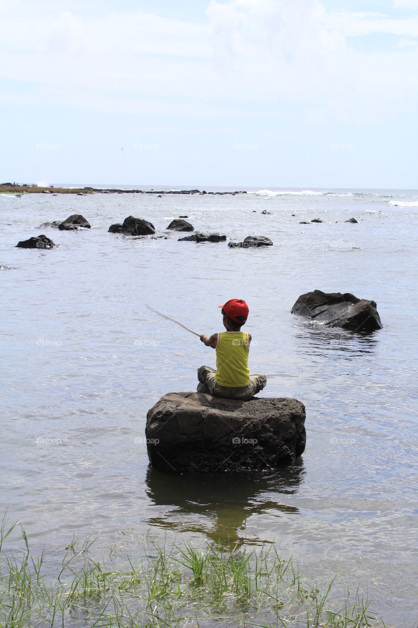 little boy. boy fishing alone