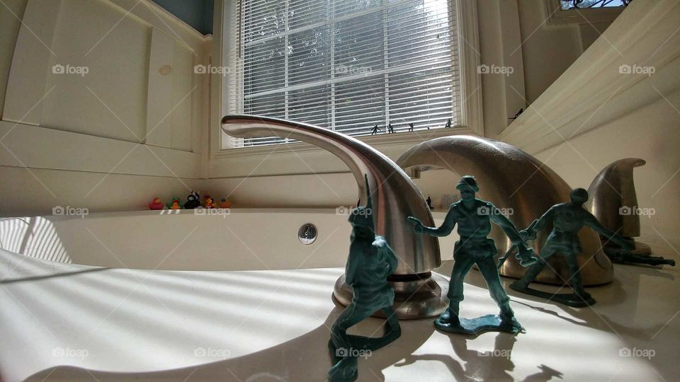 plastic army men toys face off against bathtub rubber ducky