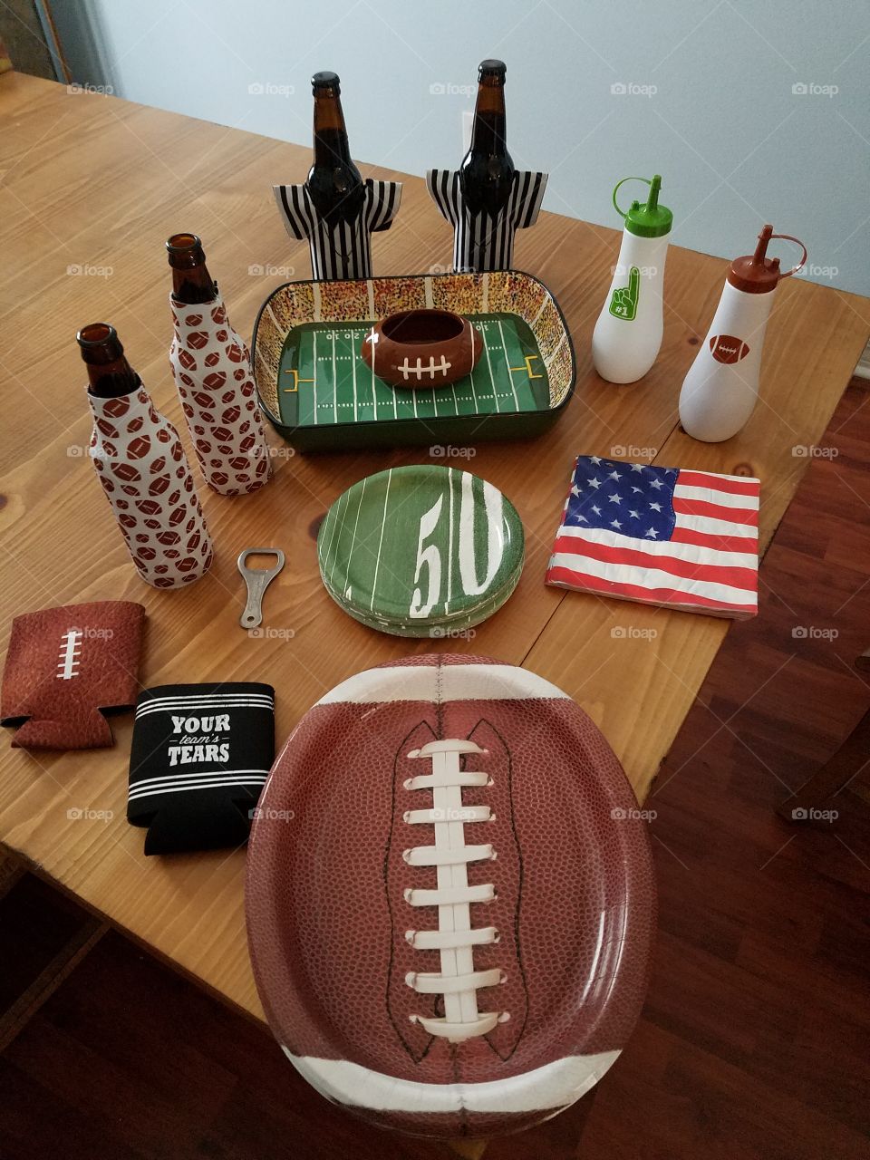Super Bowl party preparations football paper plates napkins beer koozies ceramic football chip and dip bowl bottle opener