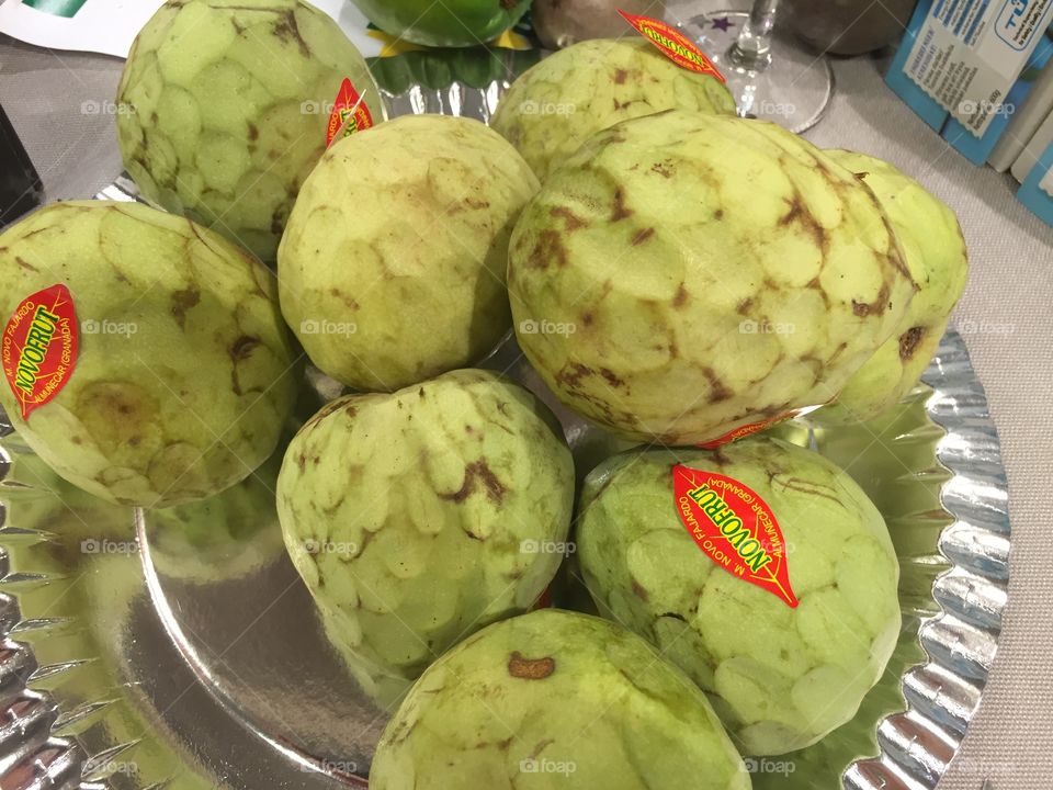 Cherimoya fruit from Spain displayed in a supermarket.