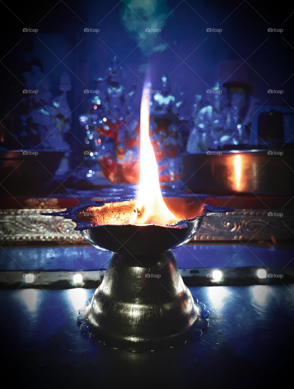Light lamp (Diya) infront of hindu gods