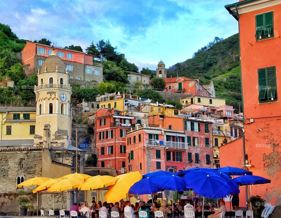 Colorful sun umbrellas below Cinque Terre, Itlay