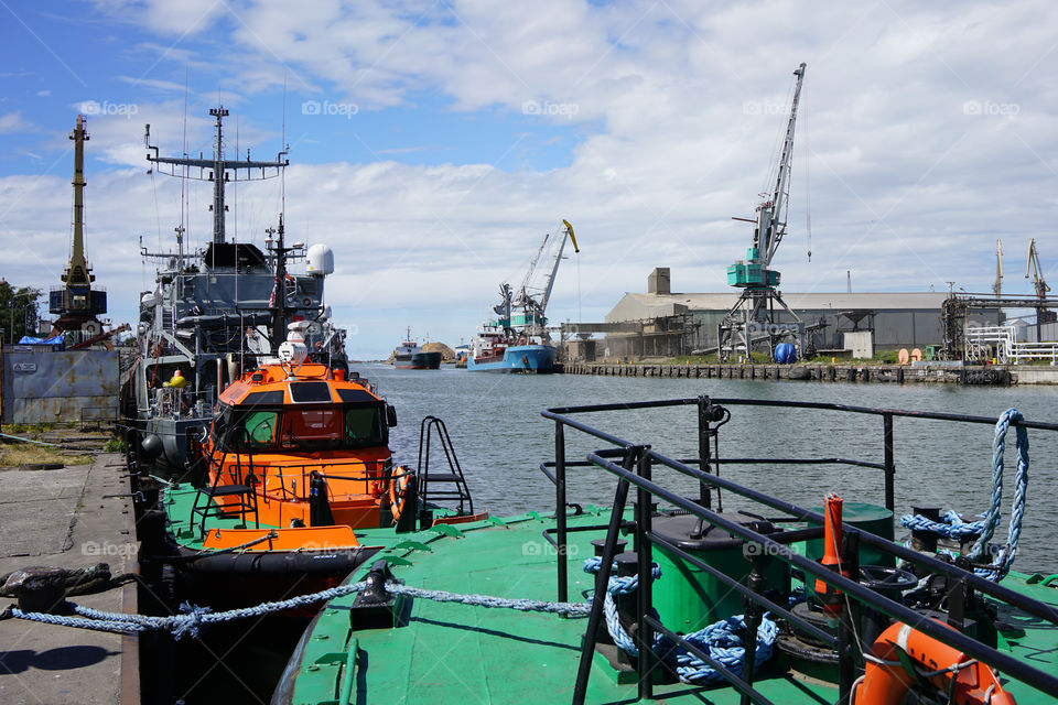 tugboat and cargo ships in the port