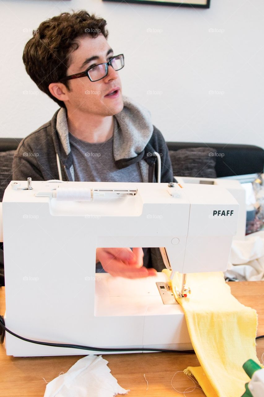 Man learning to sew