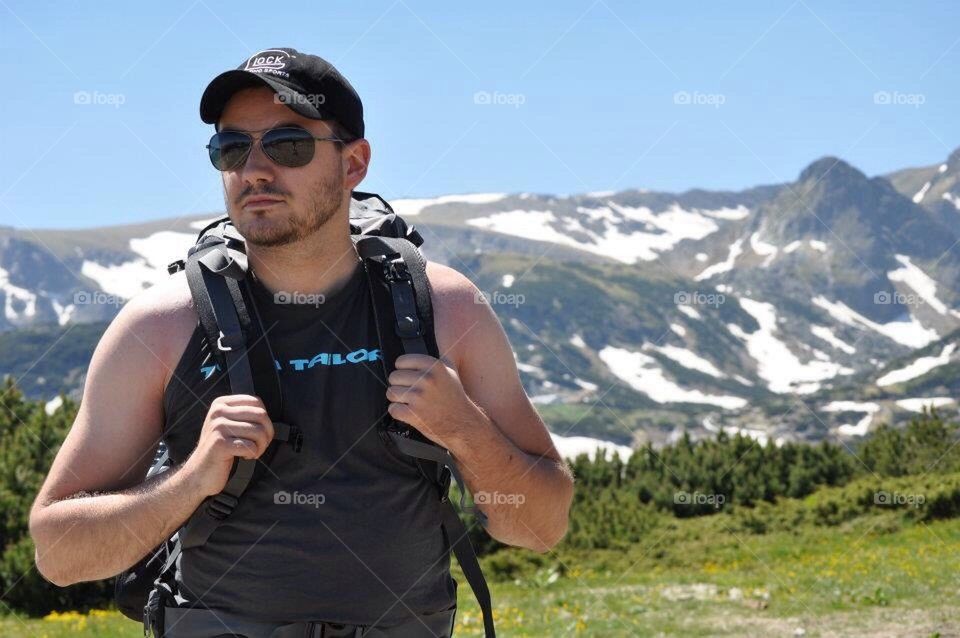 Young man on top of a mountain