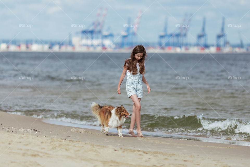 Girl with dog on the beach