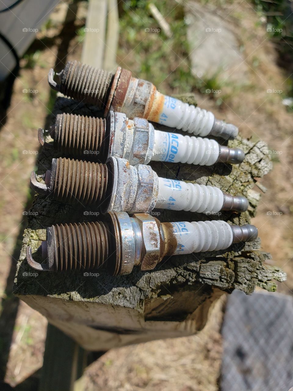used spark plugs on a post