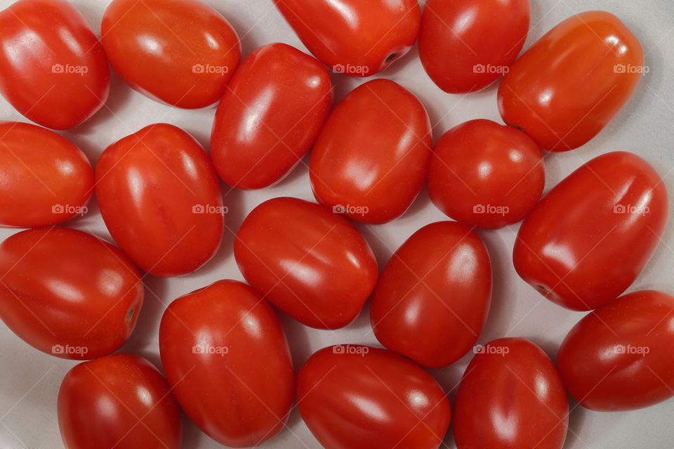 A scattering of tomatoes on a white background