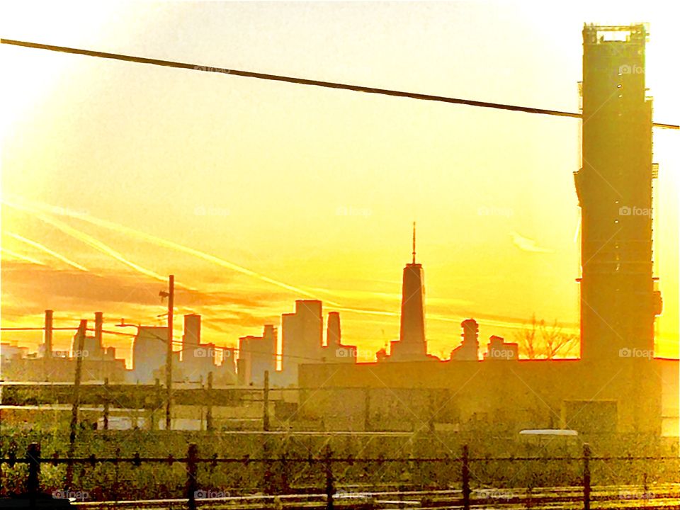 The “golden hour” is a time when the setting sun bathes everything in an intense golden light and reflections in glass windows actually appear as gleaming, shining gold and cast large flares. Examples of this can be seen in my work. Photo from 2019.