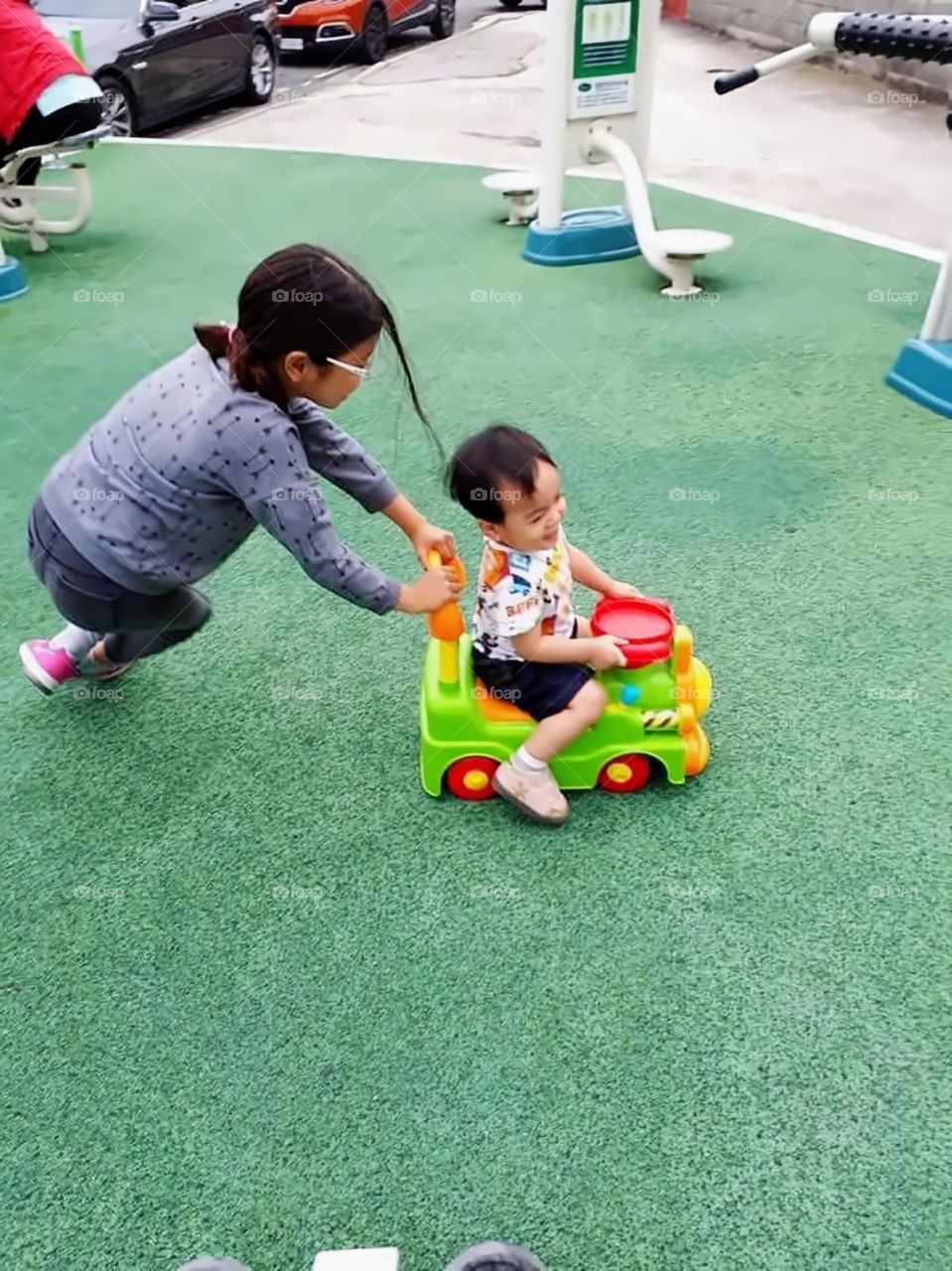 playing outside with his car makes him happy.