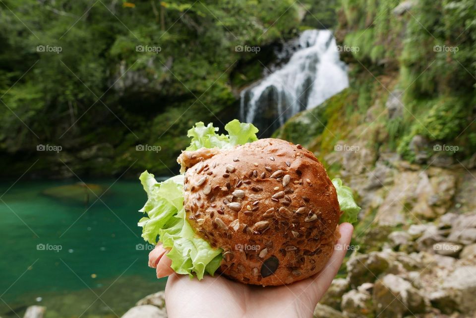 Burger in the background of waterfall