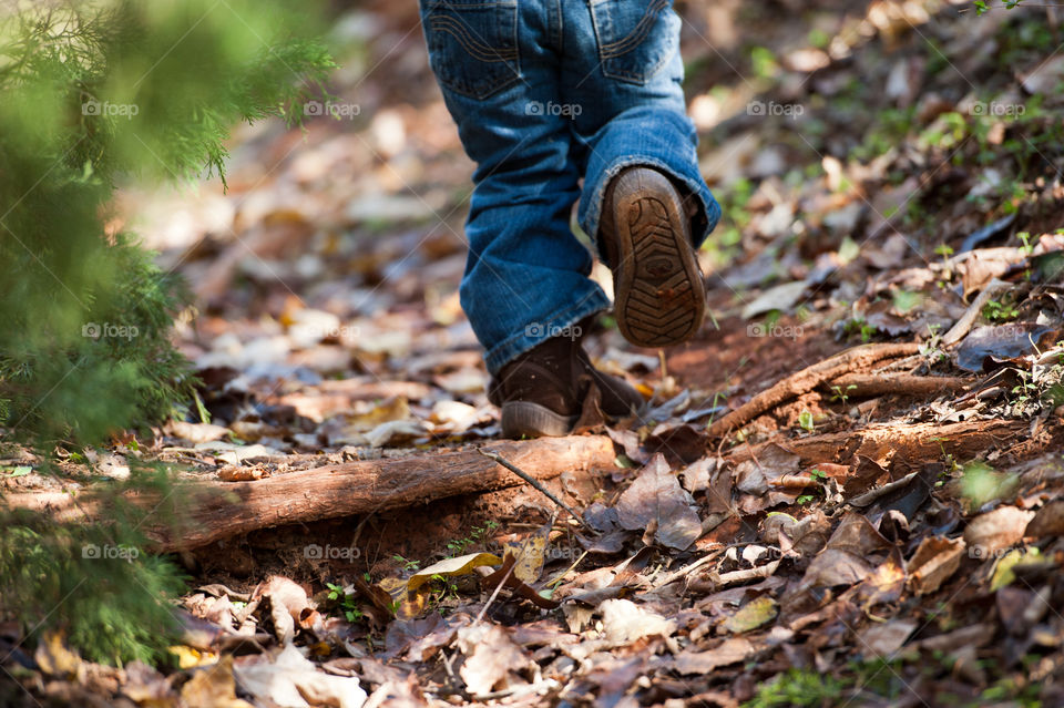 Small Hike . A young child hikes through the wilderness in boots. 