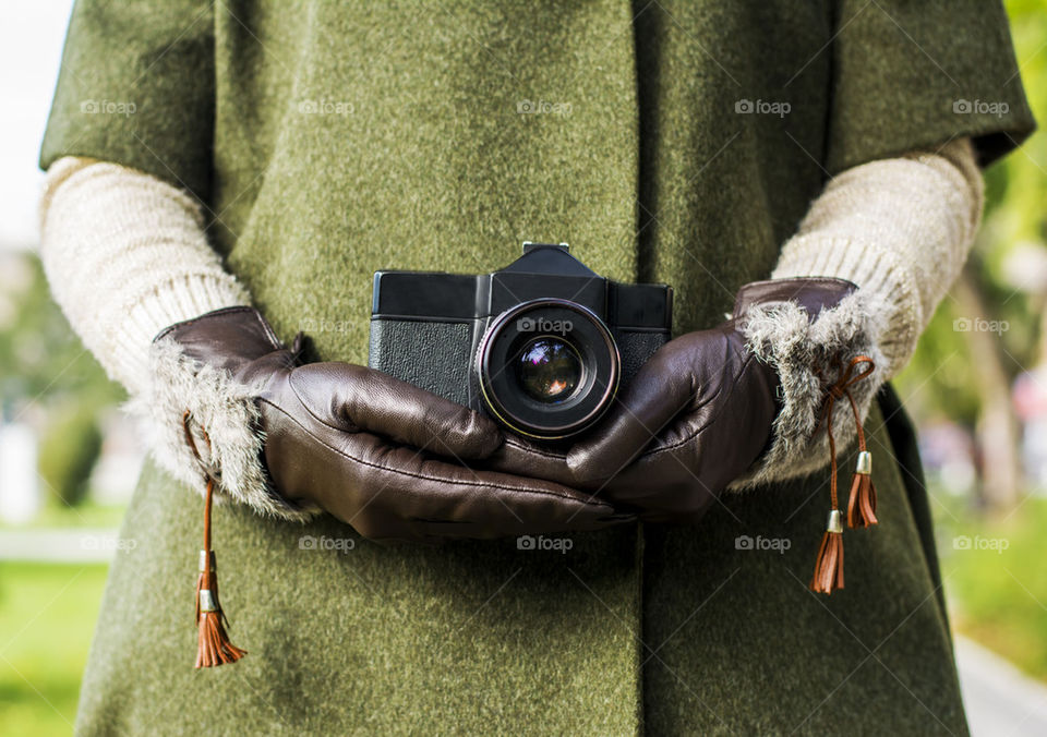 woman holding retro camera