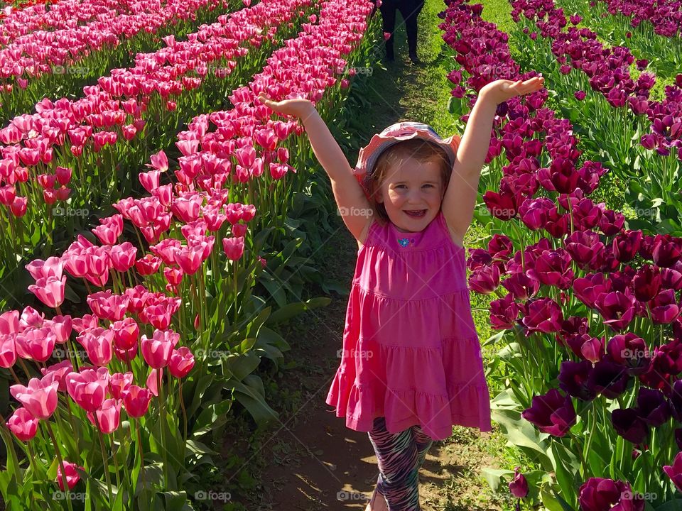 Happy girl in tulip paradise