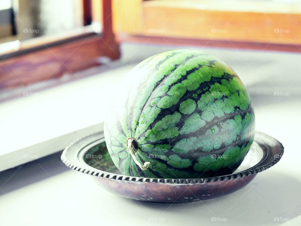 whole watermelon on the windowsill